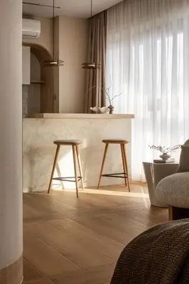 a kitchen with a counter and two stools in a room at SOFTly Landmark View City Center FREE PARKING in Kraków