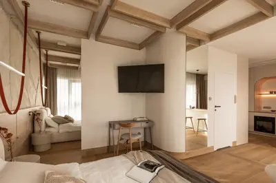 a living room with a couch and a television on a wall at SOFTly Landmark View City Center FREE PARKING in Kraków