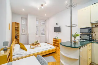 a small room with a bed and a kitchen at Piasek Studio - Old Town nearby - by Rentujemy in Kraków