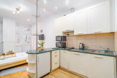 a kitchen with white cabinets and a sink at Piasek Studio - Old Town nearby - by Rentujemy in Kraków