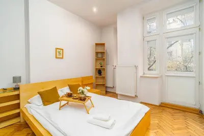 a large white bedroom with a bed and a table at Piasek Studio - Old Town nearby - by Rentujemy in Kraków