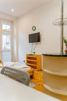 a room with two beds and a flat screen tv at Piasek Studio - Old Town nearby - by Rentujemy in Kraków
