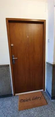 a wooden door with a sign that says betterbiology at NextToNobu in Kraków