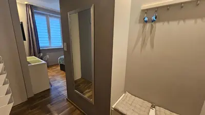 a mirror on the wall of a room at NextToNobu in Kraków