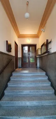 an empty hallway with stairs leading to a door at NextToNobu in Kraków