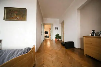 a living room with a bed and a wooden floor at Urban Nest Apartments Radziwiłłowska 17 in Kraków