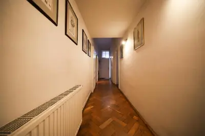 a hallway with pictures on the walls of a house at Urban Nest Apartments Radziwiłłowska 17 in Kraków