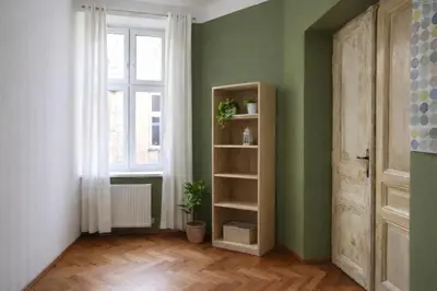 a room with a book shelf and a window at Urban Nest Apartments Radziwiłłowska 17 in Kraków