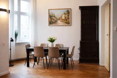 a dining room with a black table and chairs at Urban Nest Apartments Radziwiłłowska 17 in Kraków