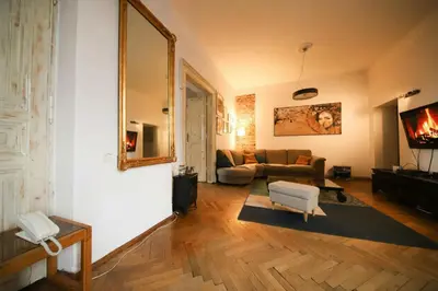 a living room with a couch and a mirror at Urban Nest Apartments Radziwiłłowska 17 in Kraków