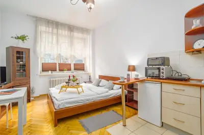 a kitchen with a couch in the middle of a room at Batorego Studio - Old Town nearby - by Rentujemy in Kraków