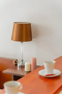 a table with a lamp and two cups on it at Batorego Studio - Old Town nearby - by Rentujemy in Kraków