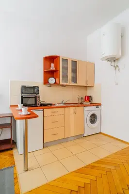a kitchen with a table and a washing machine at Batorego Studio - Old Town nearby - by Rentujemy in Kraków