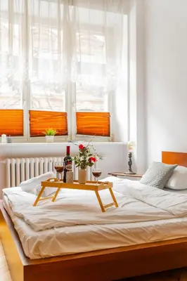 a bedroom with a large bed with a table on it at Batorego Studio - Old Town nearby - by Rentujemy in Kraków
