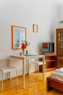a room with a table with two chairs and a television at Batorego Studio - Old Town nearby - by Rentujemy in Kraków