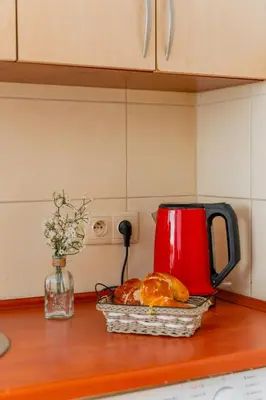 a basket of bread and a red mug on a counter at Batorego Studio - Old Town nearby - by Rentujemy in Kraków