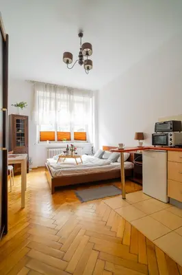 a living room with a bed and a table at Batorego Studio - Old Town nearby - by Rentujemy in Kraków
