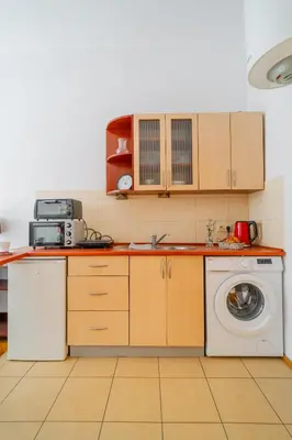 a kitchen with a washer and a washing machine at Batorego Studio - Old Town nearby - by Rentujemy in Kraków