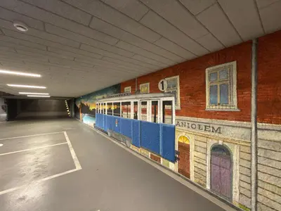 a tunnel with a train painted on the side of a building at Wawel Riverside Apartment free Parking in Kraków