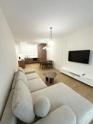 a living room with a couch and a flat screen tv at Wawel Riverside Apartment free Parking in Kraków
