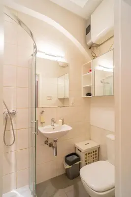 a bathroom with a toilet sink and a shower at Krakow Old Town Studio N1 - by Rentujemy in Kraków