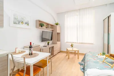 a living room with a table and a dining room at Krakow Old Town Studio N1 - by Rentujemy in Kraków