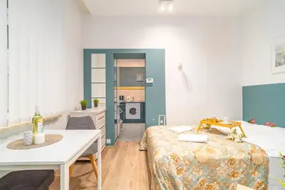 a room with a bed and a table and a kitchen at Kraków Old Town Studio N2 - by Rentujemy in Kraków