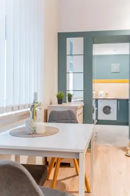 a living room with a table and a kitchen at Kraków Old Town Studio N2 - by Rentujemy in Kraków