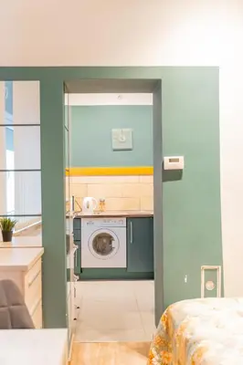 a kitchen with a washing machine in a room at Kraków Old Town Studio N2 - by Rentujemy in Kraków