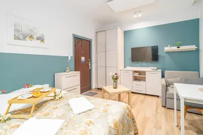 a hotel room with a bed and a tv at Kraków Old Town Studio N2 - by Rentujemy in Kraków