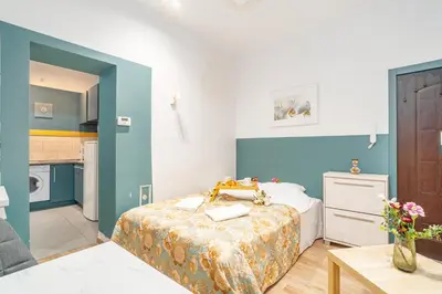 a small room with a bed and a kitchen at Kraków Old Town Studio N2 - by Rentujemy in Kraków