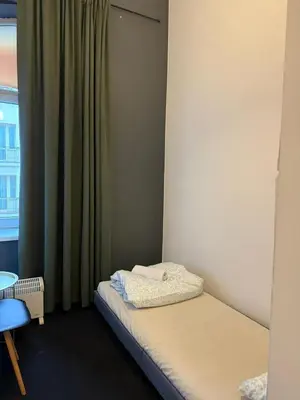 a room with a bed with a blue towel on it at Lanzo ST 48 in Kraków