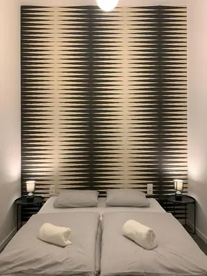 a room with two beds and a desk and a chair at Lanzo ST 48 in Kraków