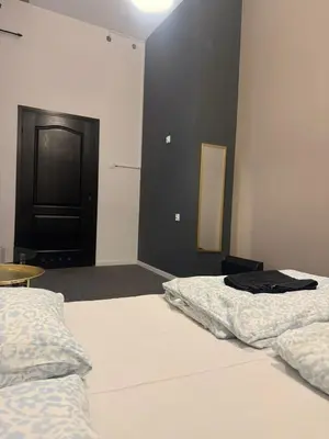 a bedroom with two beds and a black door at Lanzo ST 48 in Kraków