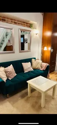 a living room with a green couch and a coffee table at Old town Krakow in Kraków
