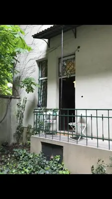a white house with a porch with chairs on it at Old town Krakow in Kraków