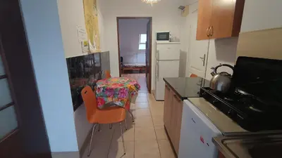 a kitchen with a table and chairs in a kitchen at Noclegi pod Sosnowym Drzewem in Pieskowa Skała