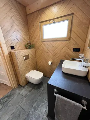 a bathroom with a toilet and a sink at Domki na granicy - Kurów in Kurów