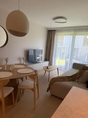 a living room with a couch and tables and a tv at Jasna Elegancja in Kraków