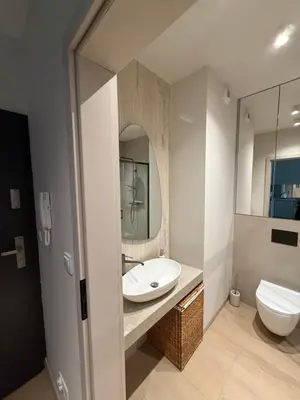 a bathroom with a sink and a toilet and a mirror at Jasna Elegancja in Kraków