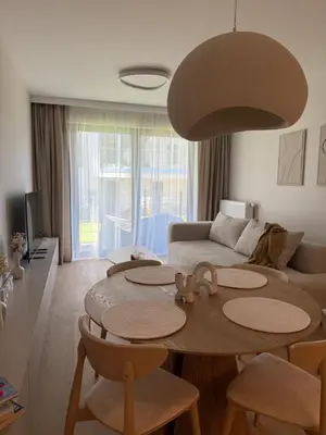 a living room with a table and a couch at Jasna Elegancja in Kraków