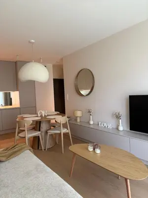 a living room with a table and a tv at Jasna Elegancja in Kraków