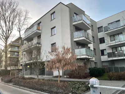 an apartment building with balconies and a parking meter at Apartament Rondo in Kraków