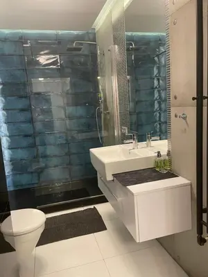 a bathroom with a sink and a toilet and a shower at Apartament Rondo in Kraków