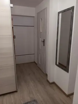 an empty room with a mirror and a door at Stacja kolejowa Kraków Płaszów in Kraków