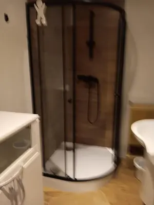 a bathroom with a shower with a toilet and a sink at Stacja kolejowa Kraków Płaszów in Kraków