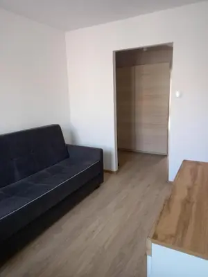 a black couch in a living room with a closet at Stacja kolejowa Kraków Płaszów in Kraków