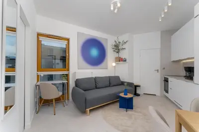 a living room with a couch and a table at Cracow Novum Apartment #533 by BookingHost in Kraków