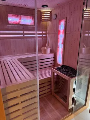 a sauna with a bench and a stove in it at Anielski Apartament z jacuzzi i sauną NOWY 2 sypialnie Relaks & SPA in Kraków