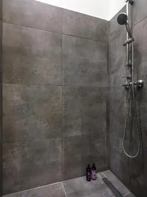 a bathroom with a shower with a shower head at Gentle Glow Suite by Tyzenhauz in Kraków